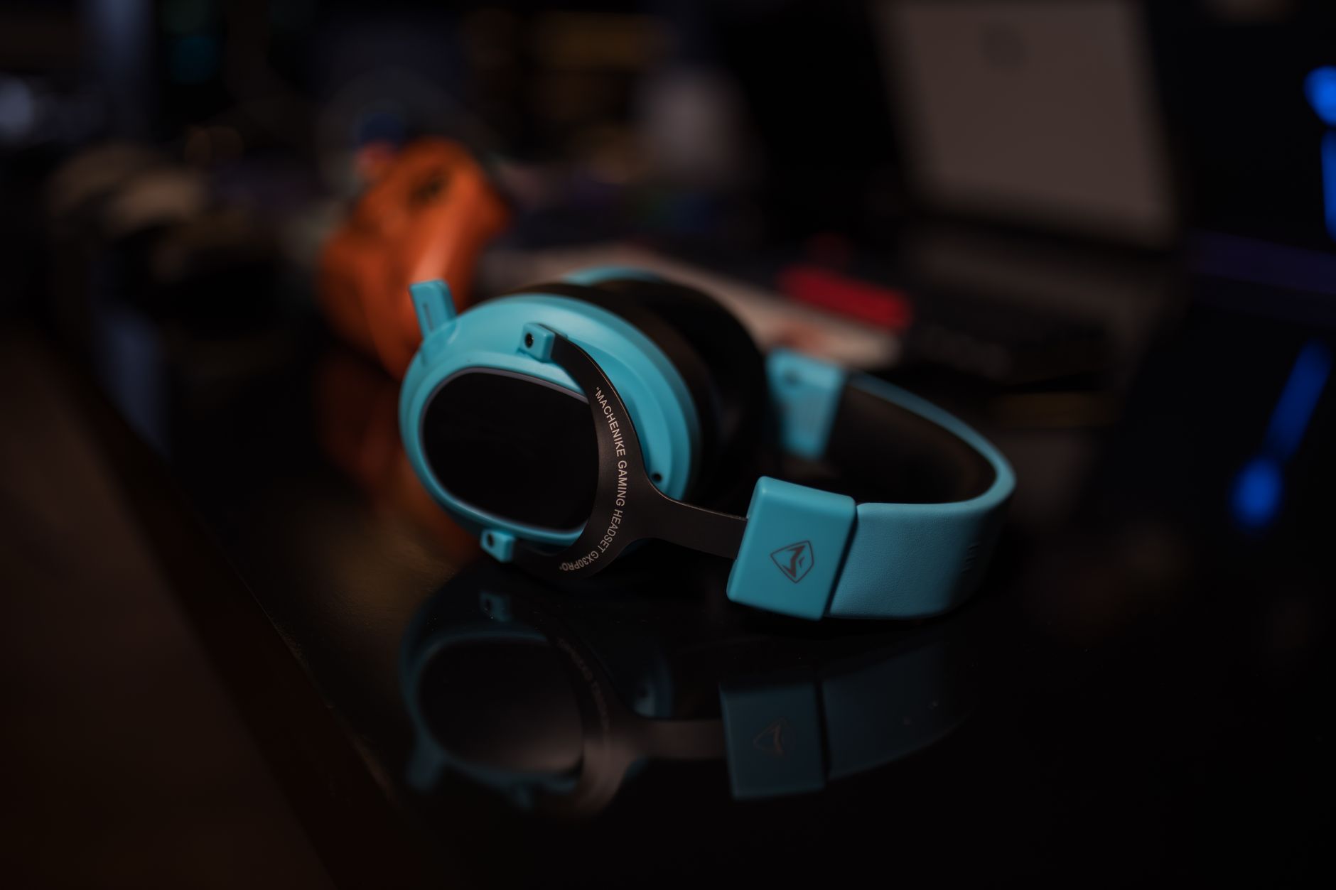 Close-up shot of a modern blue gaming headset with ambient lighting, perfect for tech enthusiasts.
