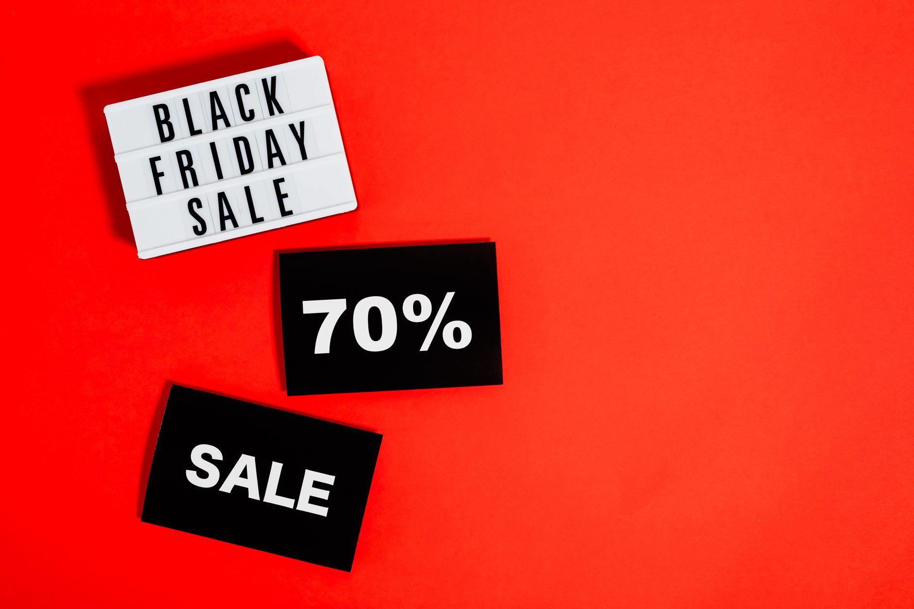 Catch the Black Friday deals with up to 70% off on a striking red background.