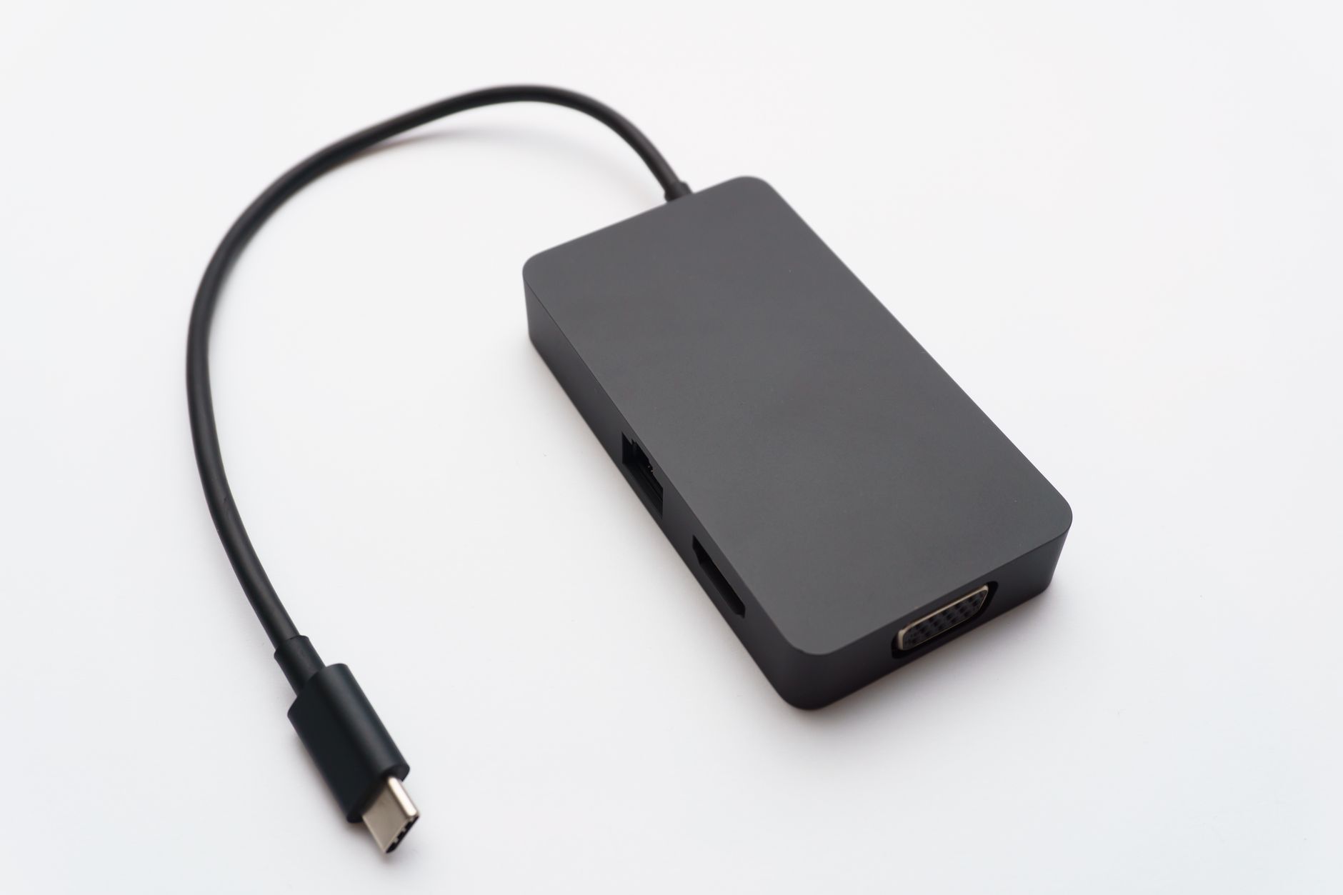 Sleek USB-C hub with HDMI, USB, and Ethernet ports on white background.