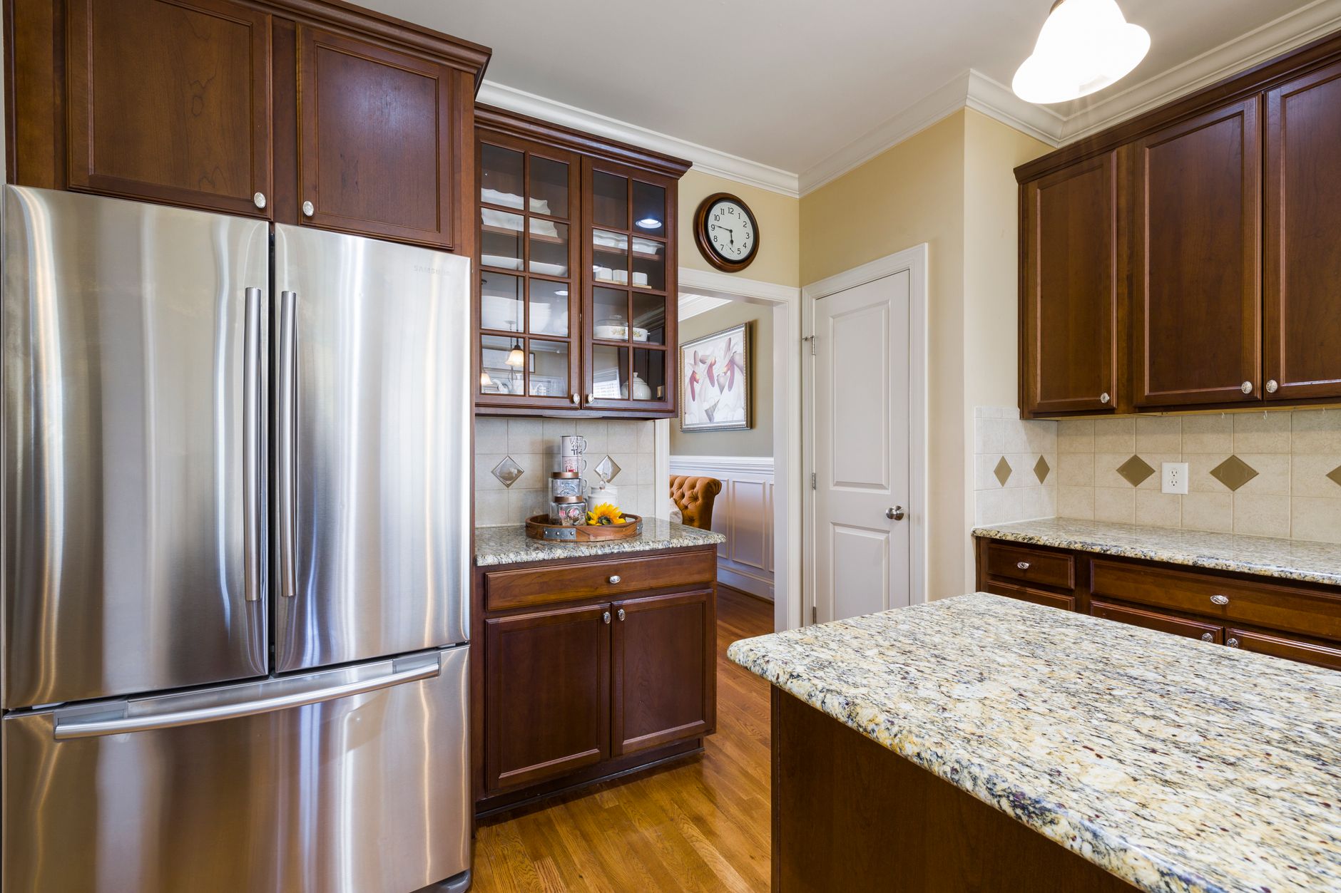 Spacious kitchen featuring stainless steel appliances and elegant wood cabinetry with granite countertops.