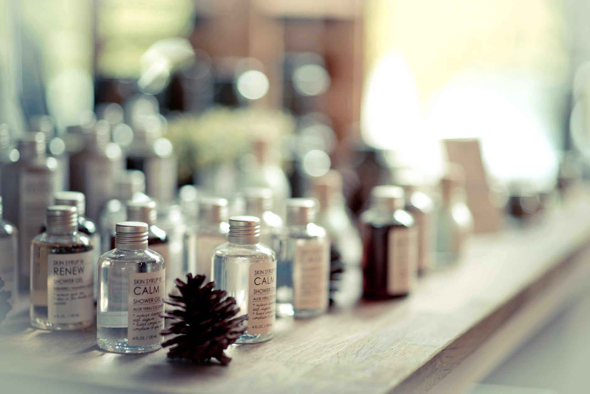 Aesthetic close-up of assorted shower gel bottles arranged on a wooden surface.