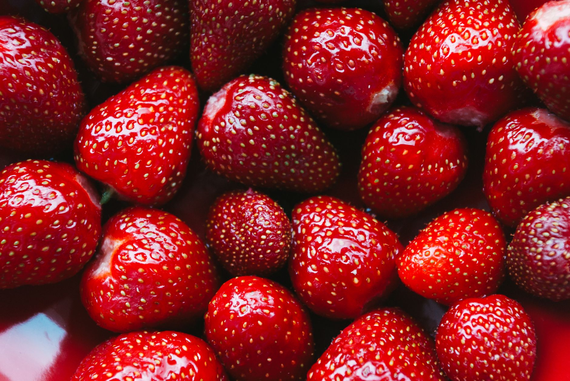 A vibrant close-up of fresh, juicy strawberries showcasing their bright red color and detailed texture.