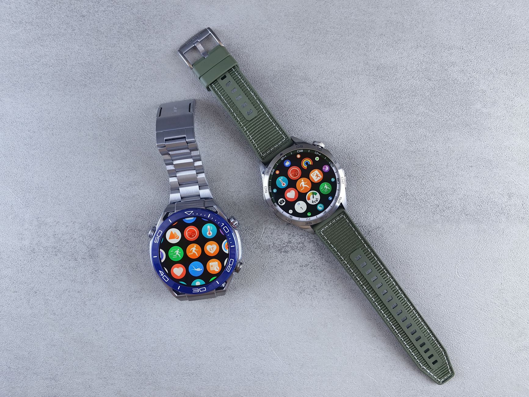 Close-up of two smartwatches on a gray background highlighting design and technology.