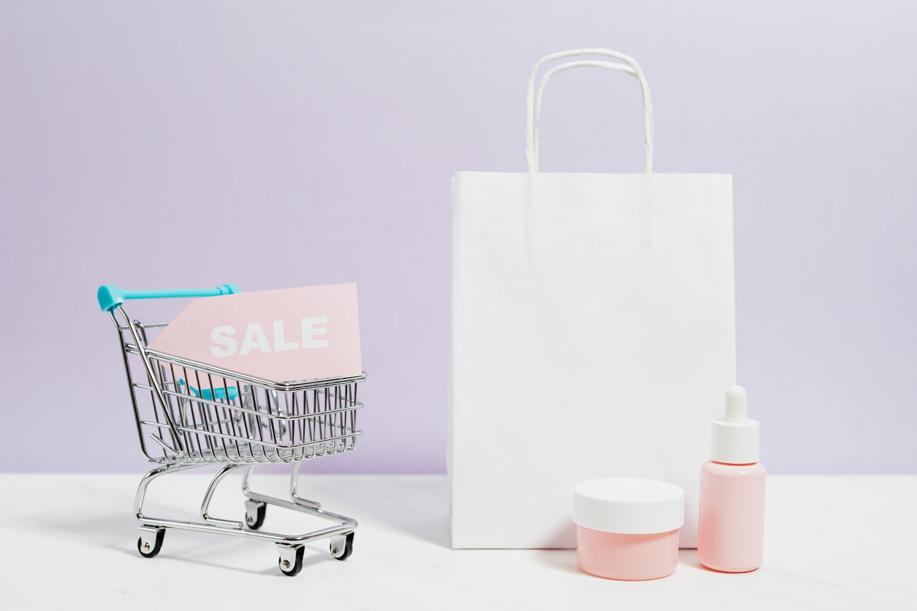 Aesthetic shopping scene with a white bag, cart, and cosmetics on sale.